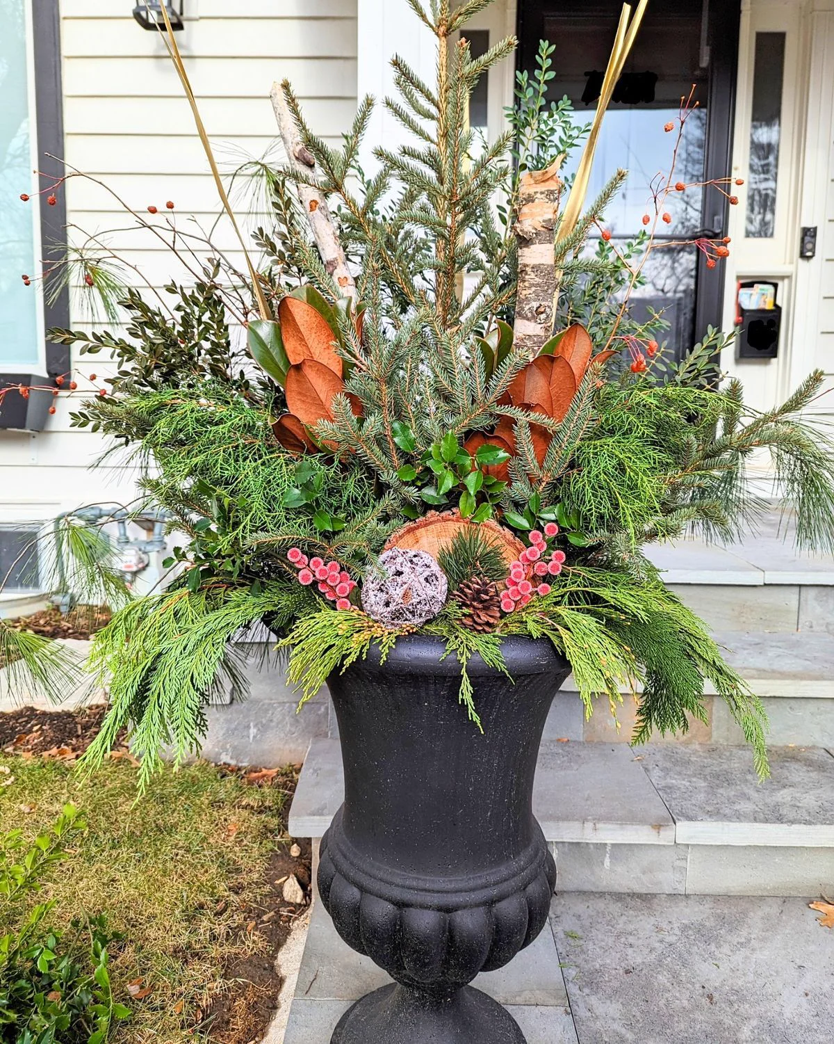 Seasonal planter arrangement with mixed foliage